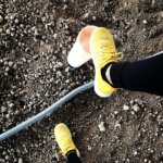 Yellow runner shoes on dirt